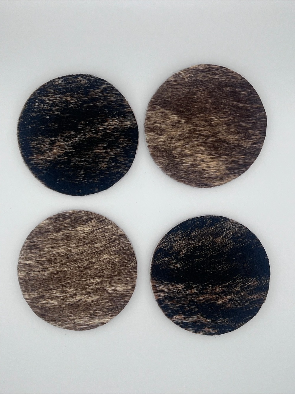 Set of 4 Round Cowhide Coasters in Brown and Black